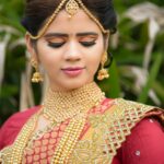 Beautiful Indian bride in embellished traditional attire during a photoshoot.